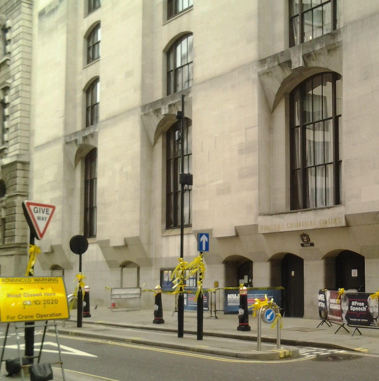 Old Bailey, London, with yellow ribbons tied on lampposts and banners in support of Julian Assange