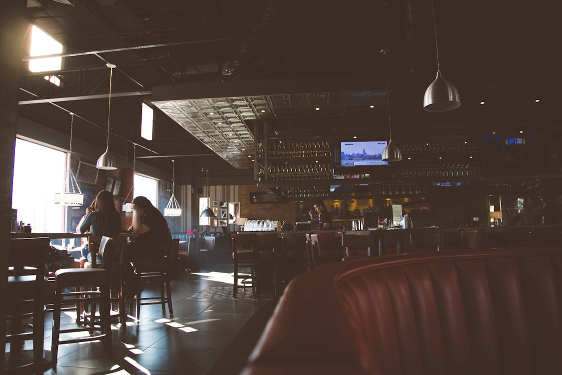 Free Warm interior scene of a Paraguayan restaurant with patrons at tables, showcasing ambient lighting. Stock Photo Free Warm interior scene of a Paraguayan restaurant with patrons at tables, showcasing ambient lighting. Stock Photo