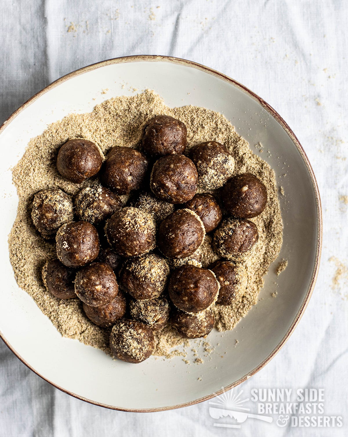 A bowl with wheat germ and energy balls.