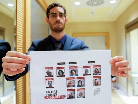 Navad Kipnis holds a family tree showing how the Hamas invasion impacted his relatives