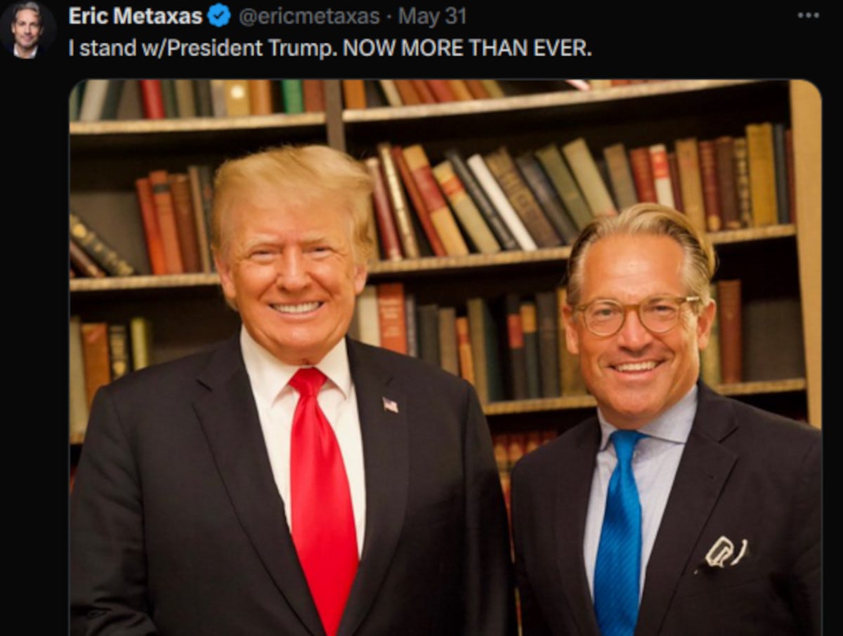 Photo of Trump and Metaxas with shelf of books behind them.