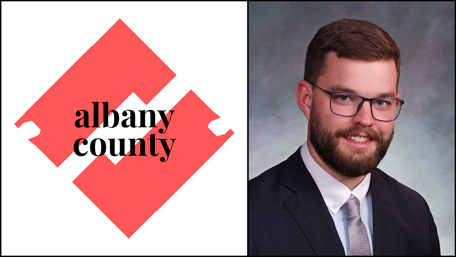 Andrew's official portrait aside a stylized graphic logo for Albany County