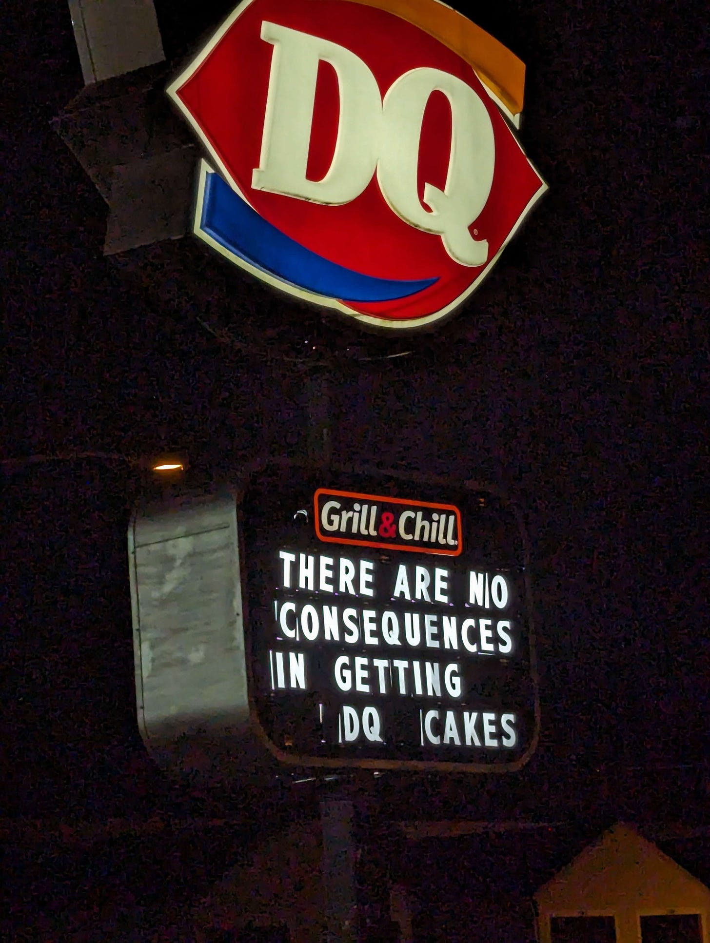 a Dairy Queen sign at night that says THERE ARE NO CONSEQUENCES IN GETTING DQ CAKES