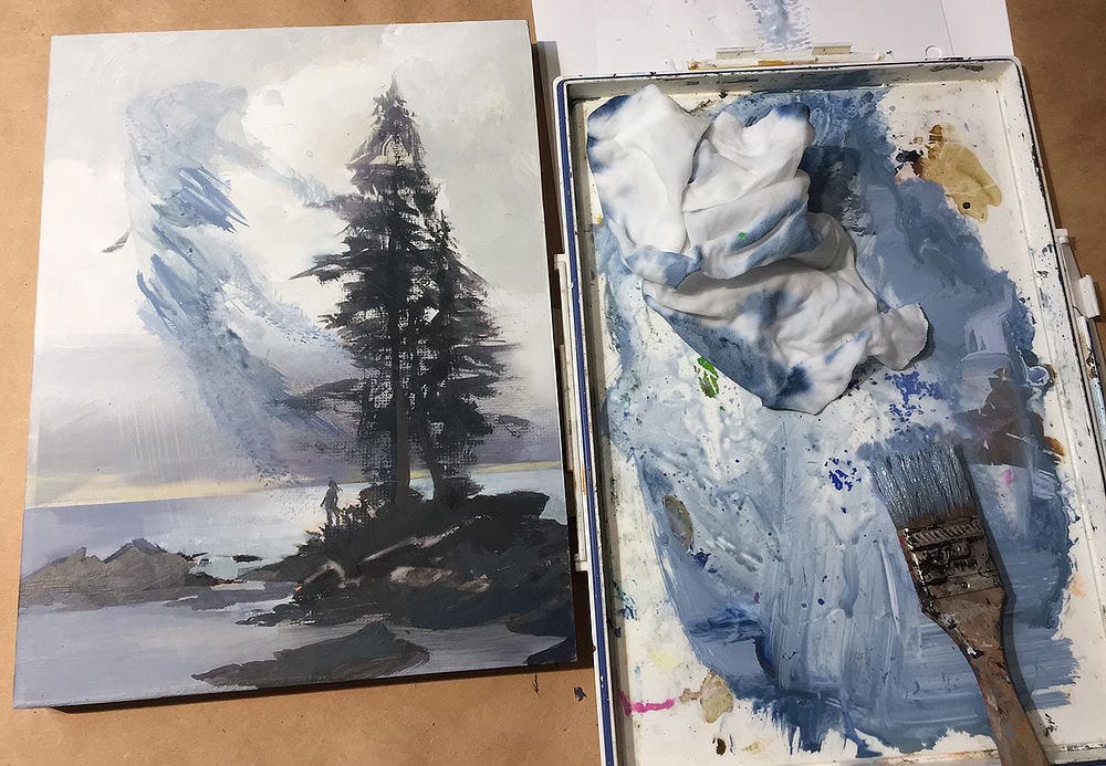 Work in progress side by side with a tray containing a brush, cobalt paint, and a rag. The art has been smeared with the rag so the rough shape of the figure not yet rendered is taking shape.