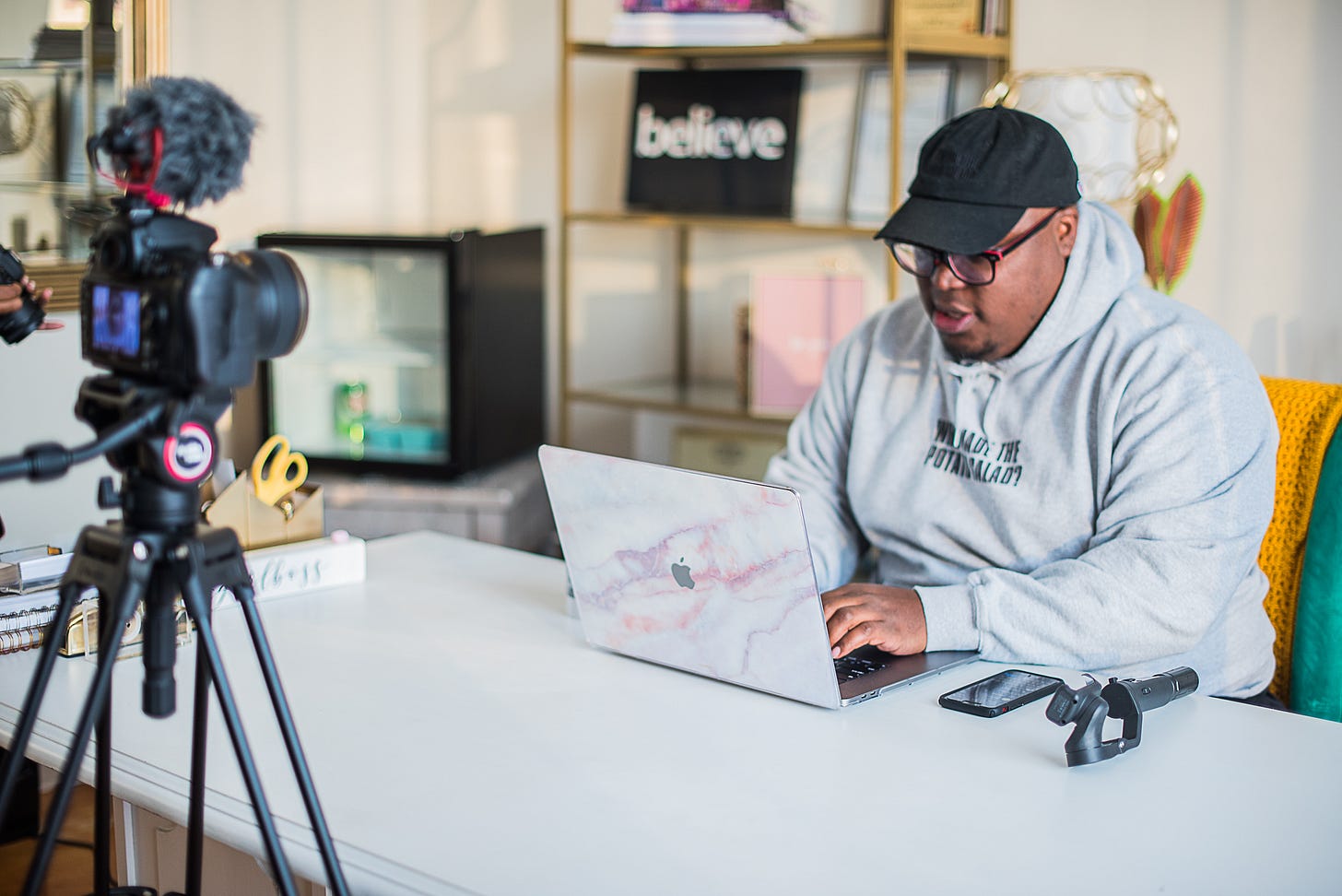 A picture of KJ Kearney faux typing for a photoshoot.