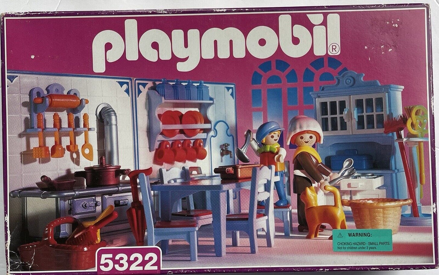 Vintage pink box of Victorian Playmobil kitchen set with blue table and chairs, stove, adult figurine, child figurine, and kitchen accessories. 
