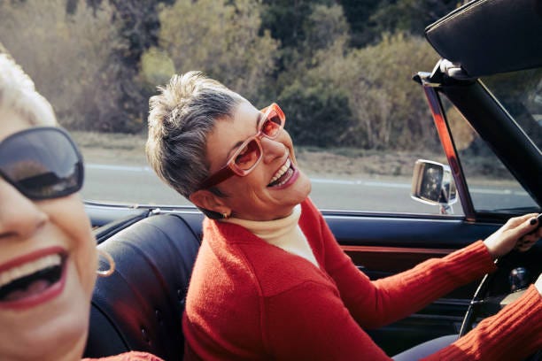 happy mature women driving in convertible car - open road stock pictures, royalty-free photos & images