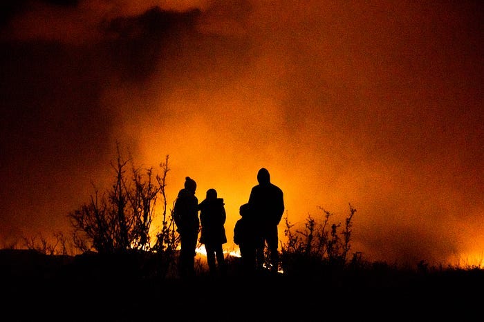 family against a wildfire in the night