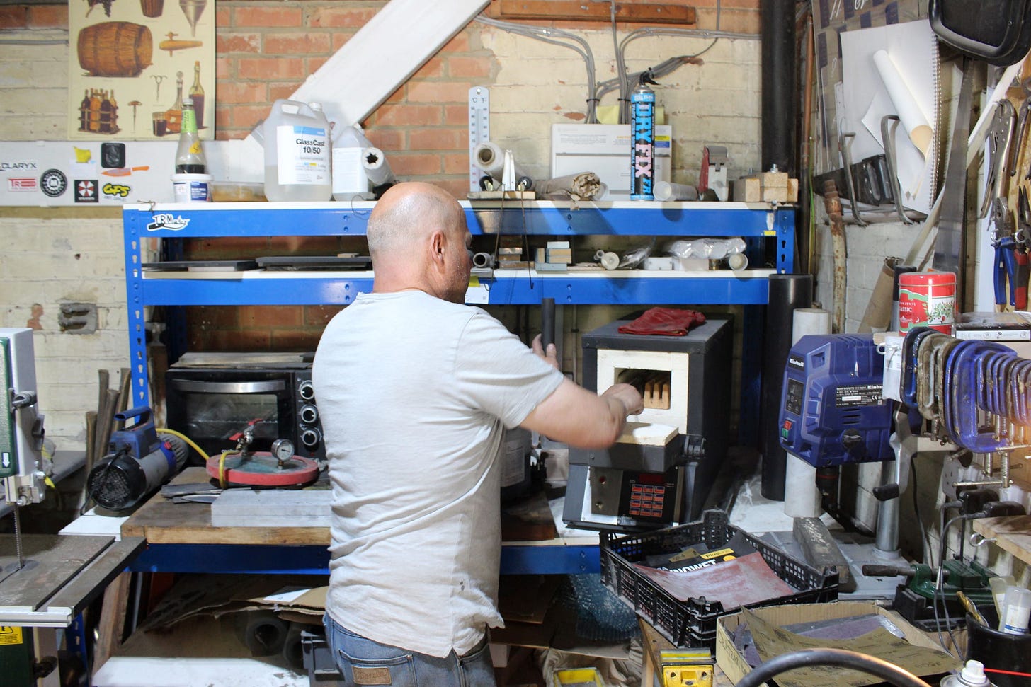 Bernard at the back of his workshop taking blades out of the oven