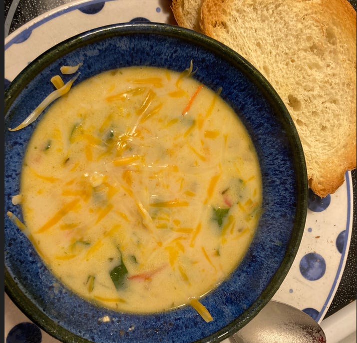 bowl of soup on a plate with toast