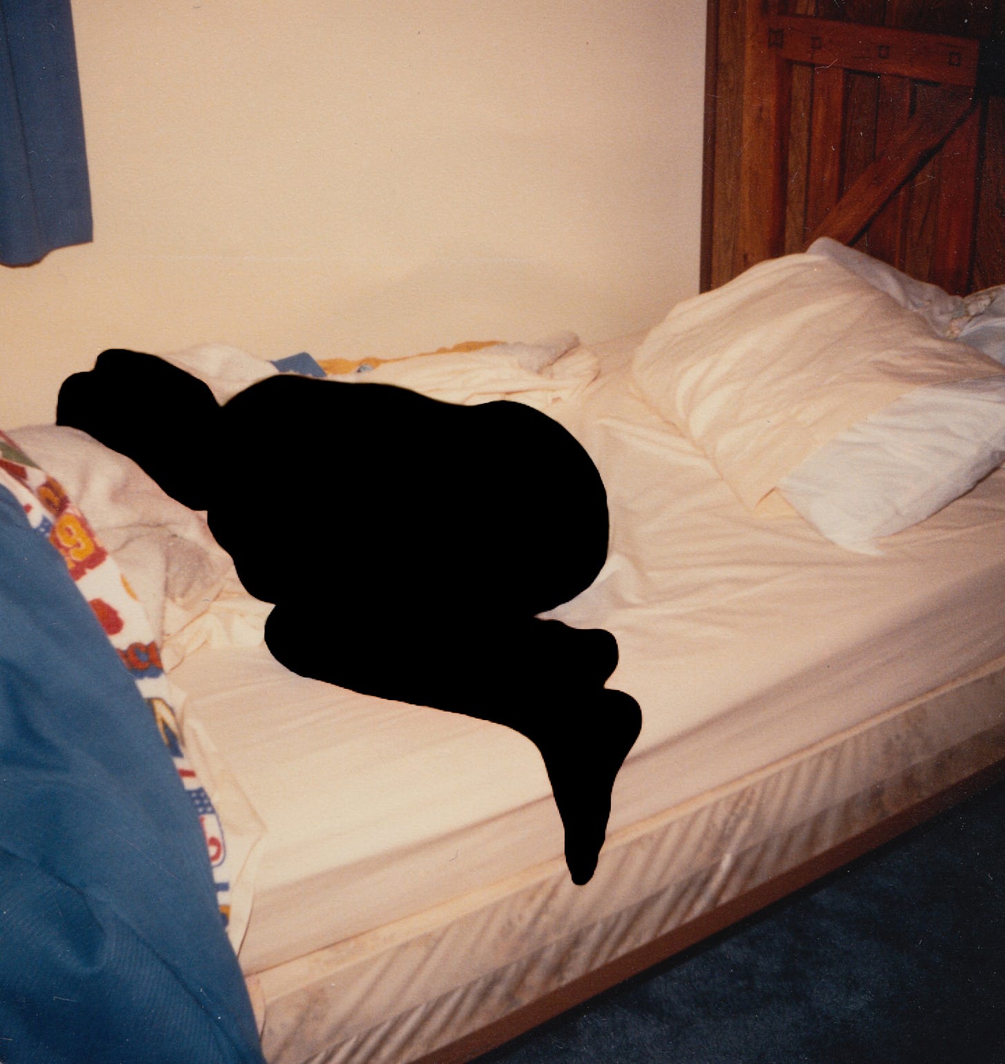 A silhouette of my brother curled napping in bed as a child.
