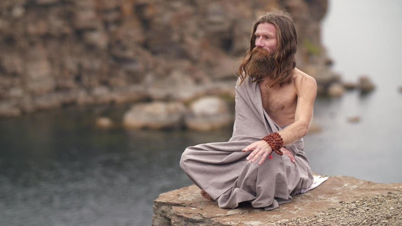 Spiritual man meditating by the sea - Free Stock Video