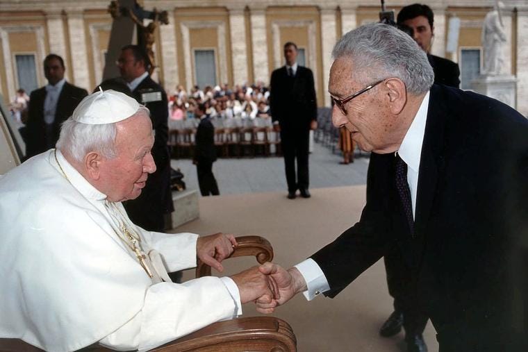 Pope John Paul II shakes hands with former U.S. Secretary of State Henry Kissinger during the May 23, 2001, general audience in St. Peter’s Square.