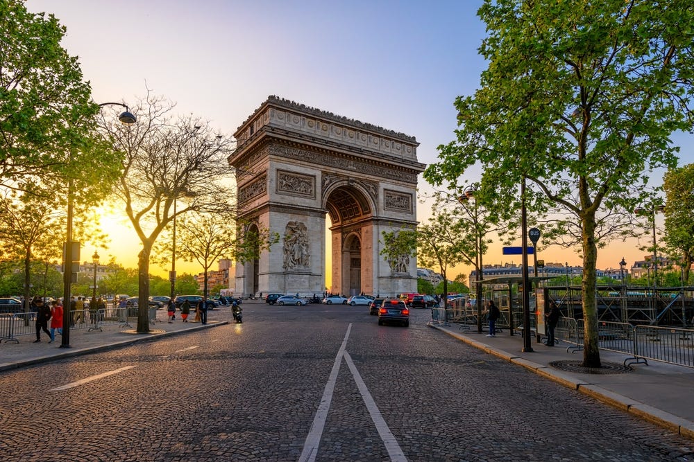 May be an image of 6 people and the Arc de Triomphe