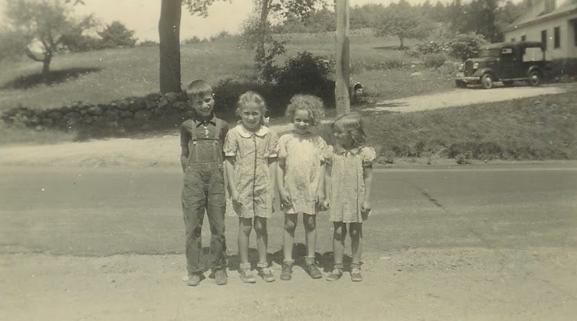 Four children in front of house