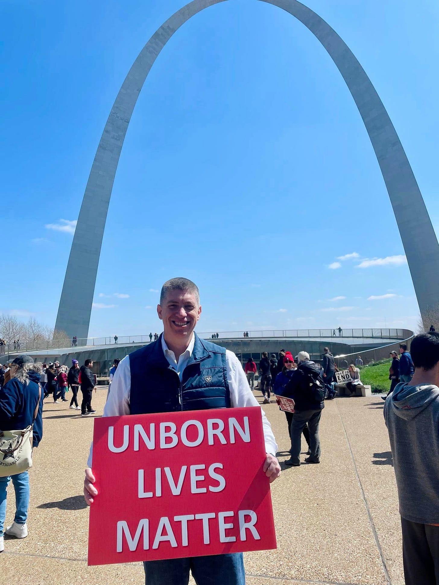May be an image of 6 people, the Gateway Arch and text that says 'UNBORN LIVES MATTER'