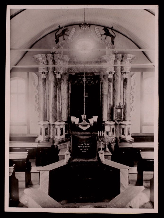 A black and white photo of a small church

Description automatically generated
