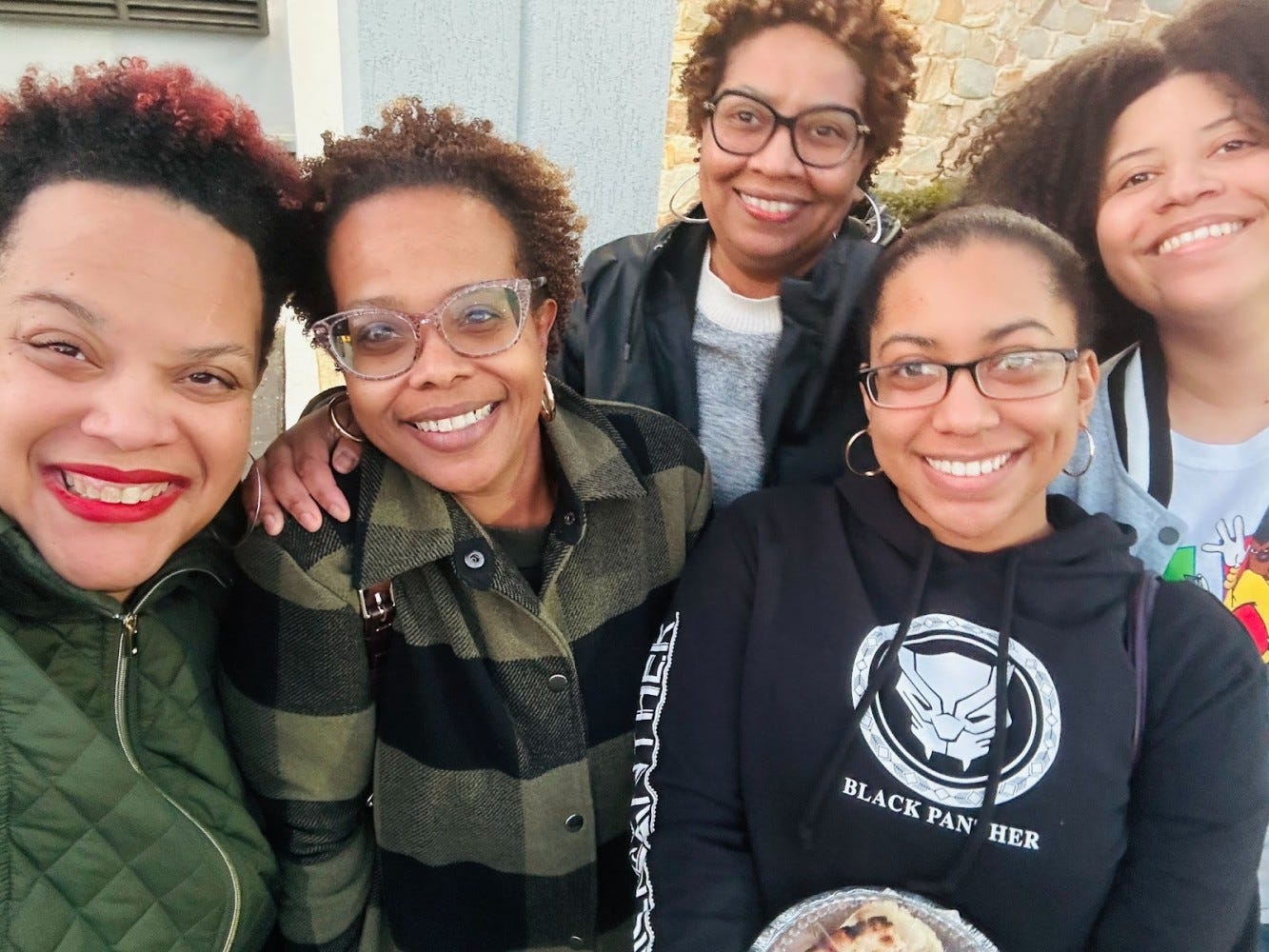 Dawn surrounded by a smiling groups of sisters and cousins