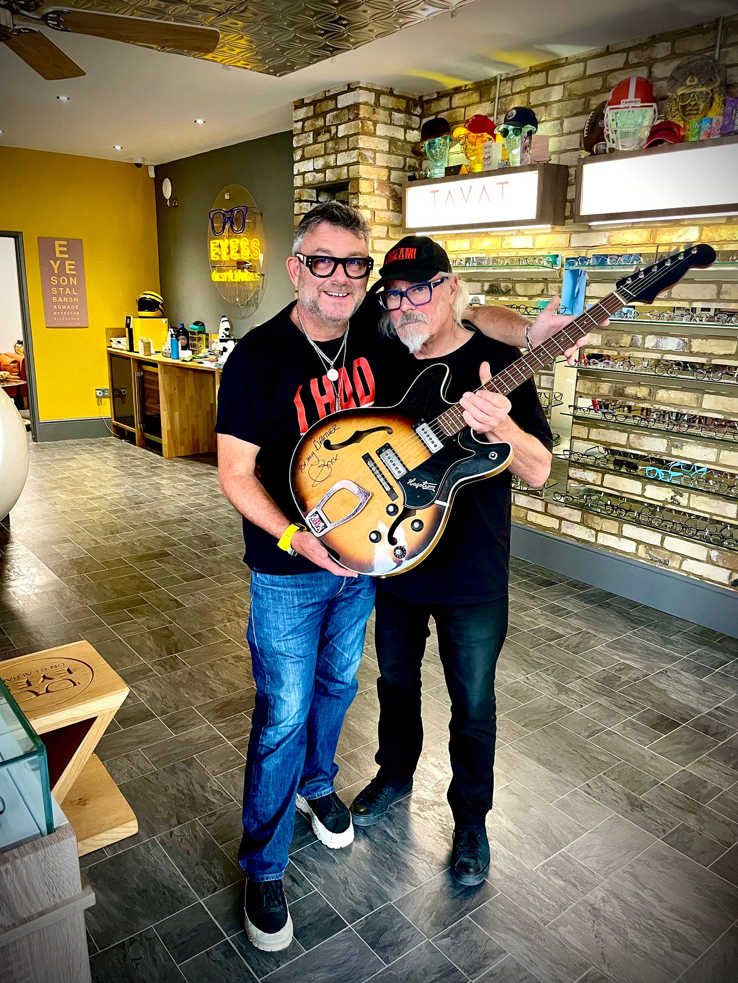 Jez Levy and Simon Campbell holfing a Hagstrom guitar at Eyes on St Albans