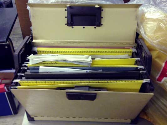 Photo of a concertina document filing box, open.