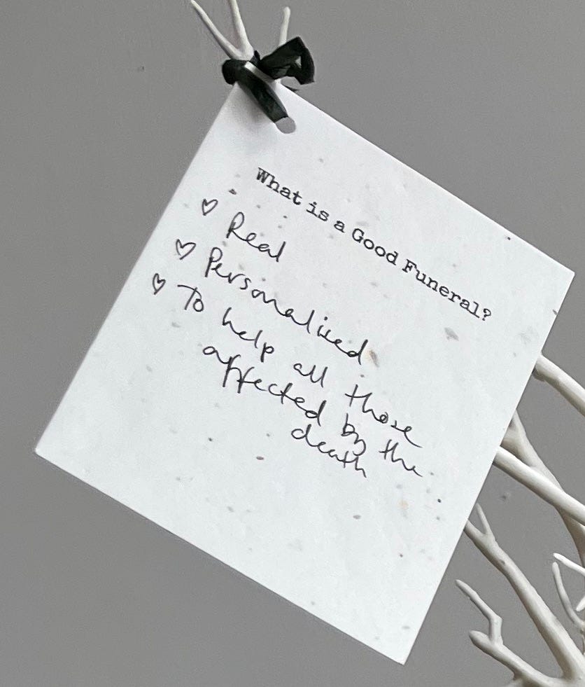 Image of card with the typed text "What is a good funeral" and a handwritten answer: "Real. Personalised. To help all those affected by the death".