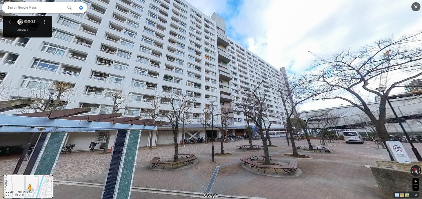 A Street View screengrab of a massively wide apartment building in Osaka, taken from its courtyard. I used to live there.