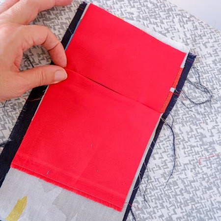 welt fabric folded at the top edge of the pocket opening