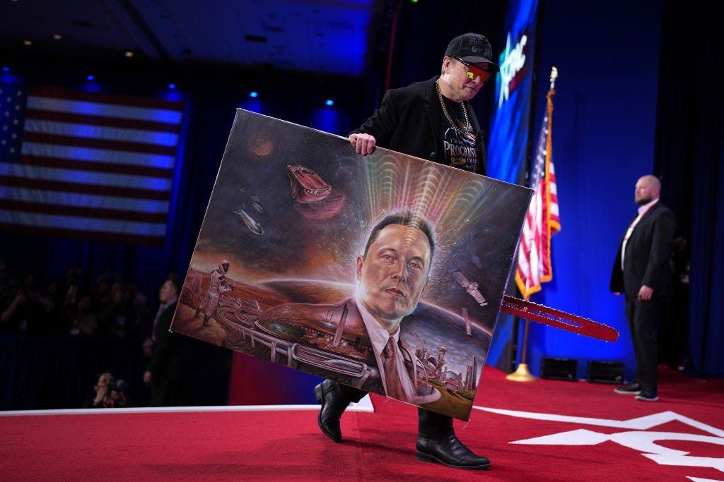 Elon Musk, carrying a chainsaw given to him by Argentine leader Javier Milei and a bizarre painting of him superimposed on a psychedelic Martian landscape, at the CPAC conference.