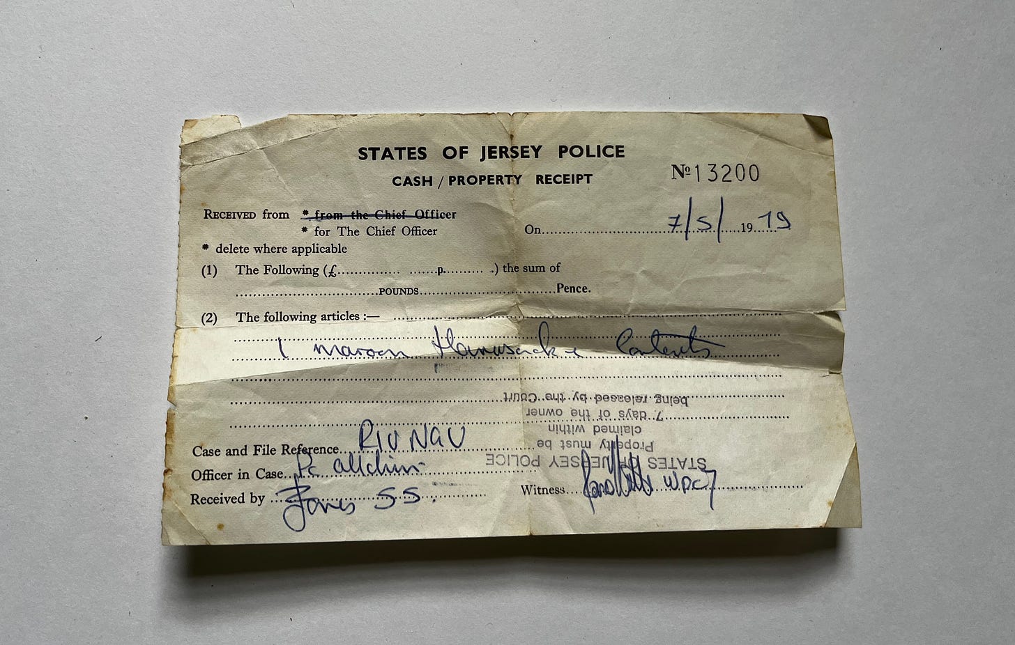old and worn receipt from the States of Jersey Police for 1 maroon rucksack, dated may 1979