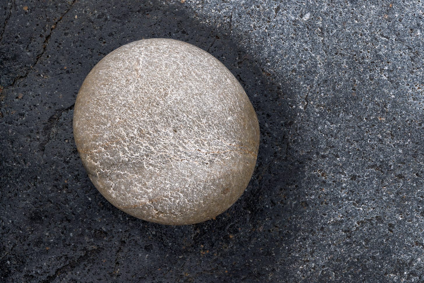 The presence of this round cobble shaped the dampness from the previous tide as it evaporated from the bedrock below in Acadia National Park, Isle au Haut, Maine.