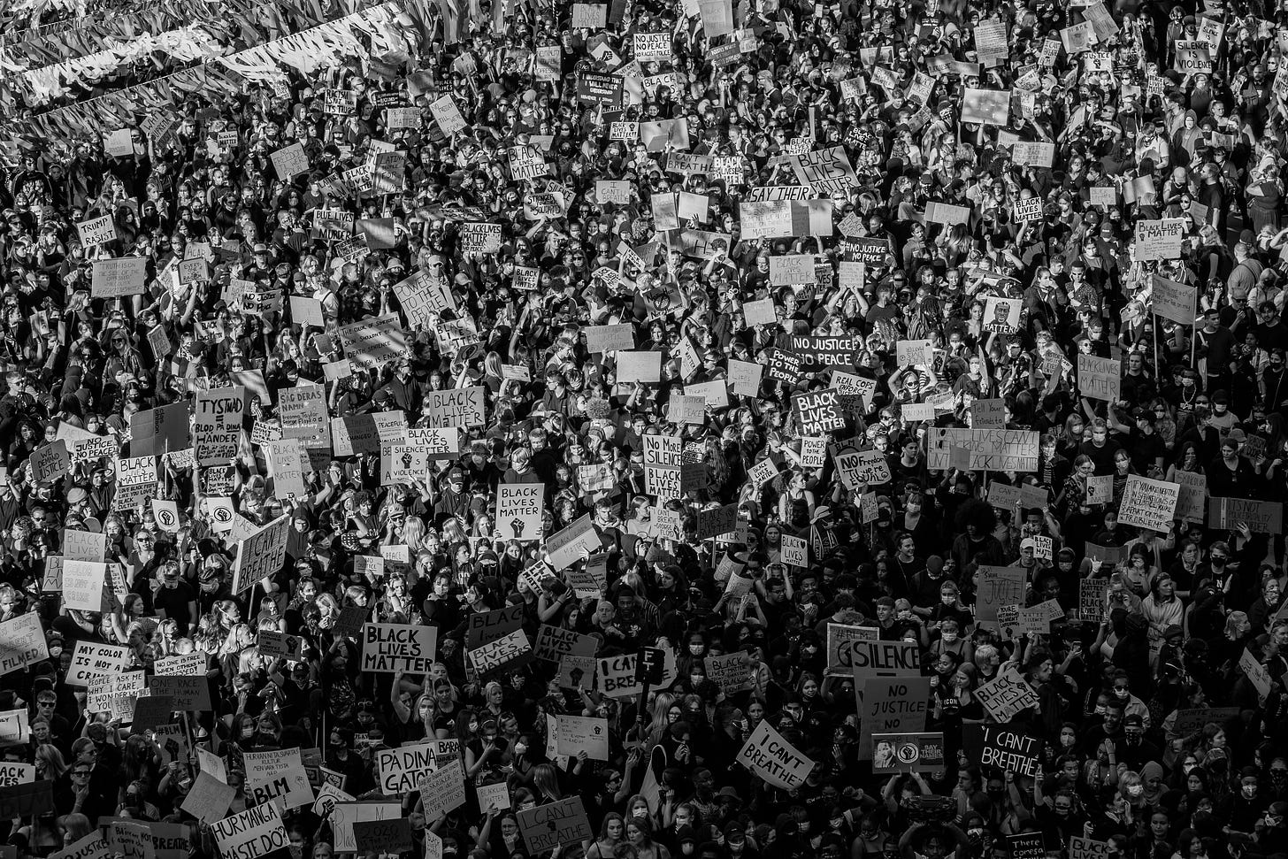 Photograph of thousands of protesters, carrying signs. Photograph by Teemu Paananen. 