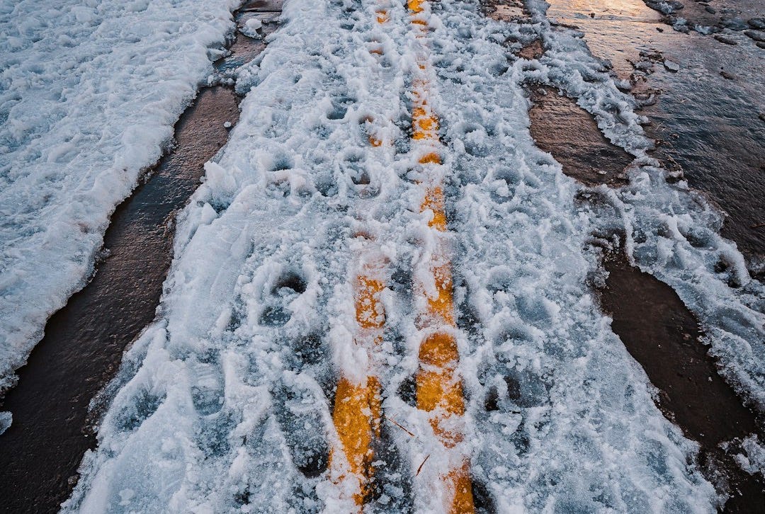 a road that has some snow on it a road that has some snow on it