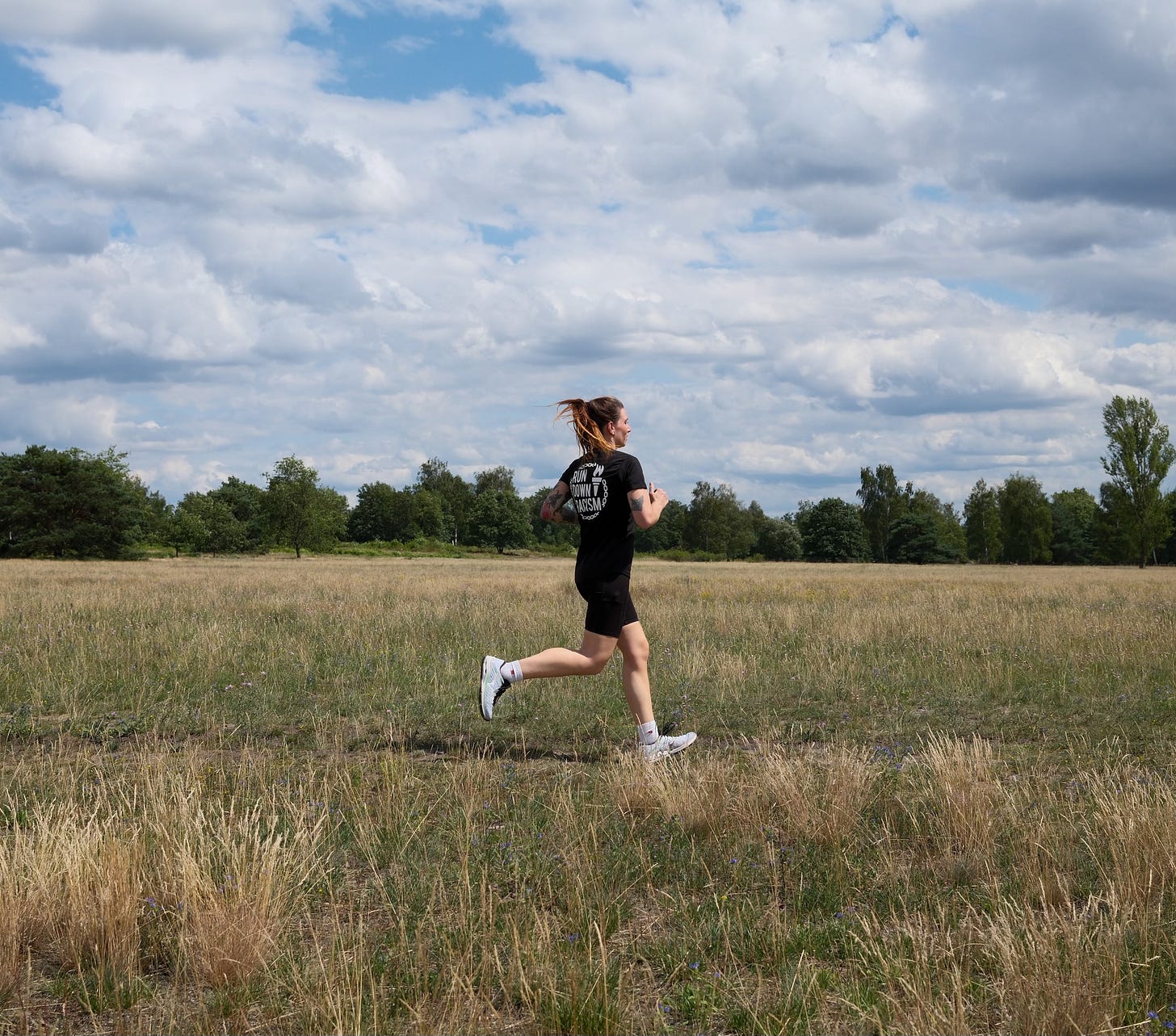 Female runner running over a field