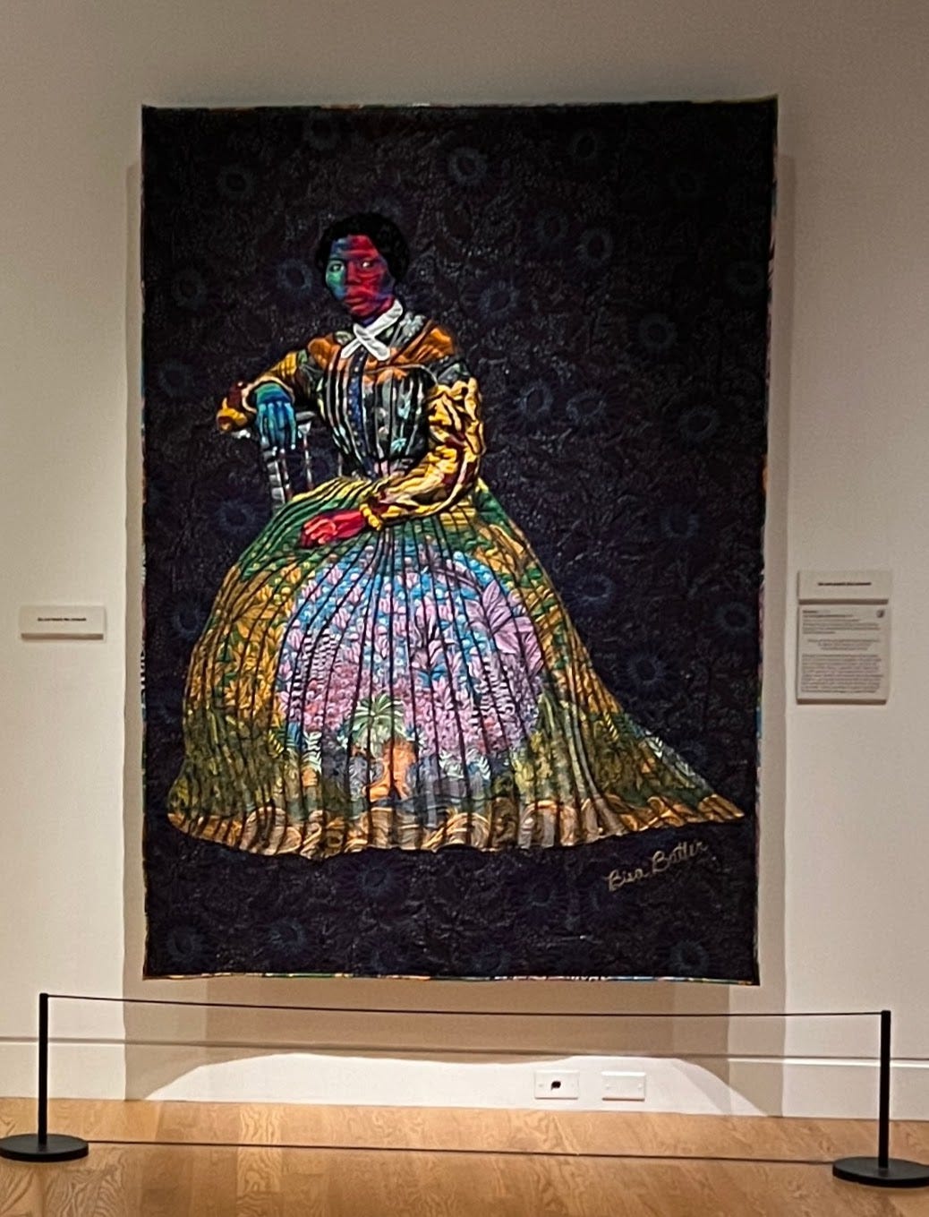 An image of Harriet Tubman depicted using brightly colored quilted cloth.