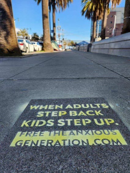Chalk stencil that says "When adults step back, kids step up."