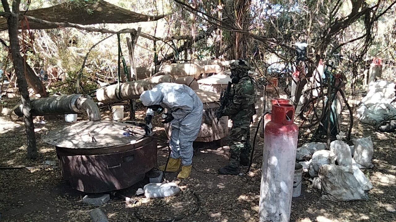 Members of the Mexican Navy soldiers stand next to a drug lab seized in Culiacan