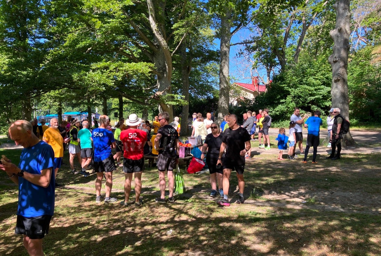 Finishers in parkrun t-shirts chatting at the finish