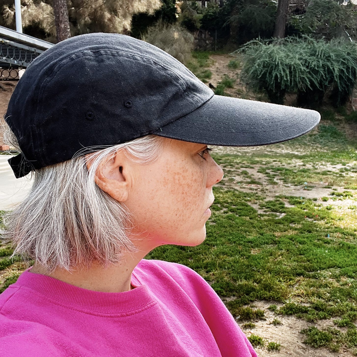 A photo of the author in profile showing the long-billed hat she runs in.