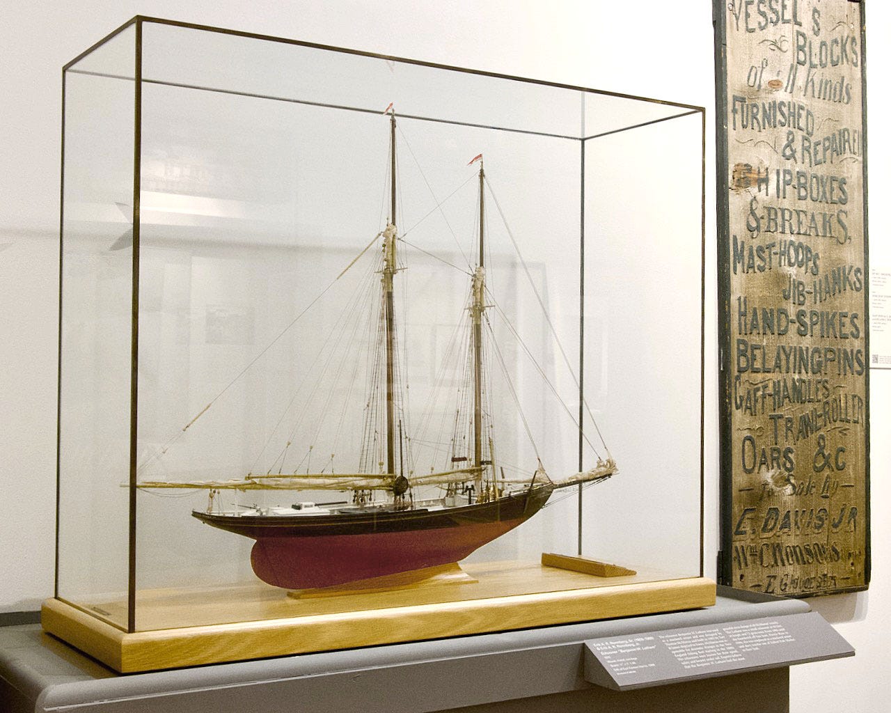 A model of a boat in a glass case

Description automatically generated