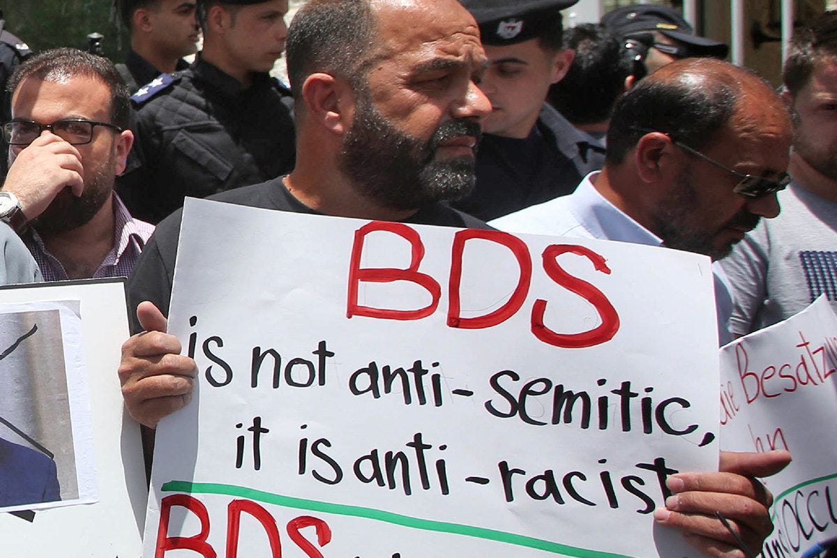 A protest condemning Germany for calling the Boycott, Divestment, Sanctions (BDS) movement anti-Semitic outside of Germany's Representative Office in the West Bank, 22 May 2019 [AFP/Getty Images]