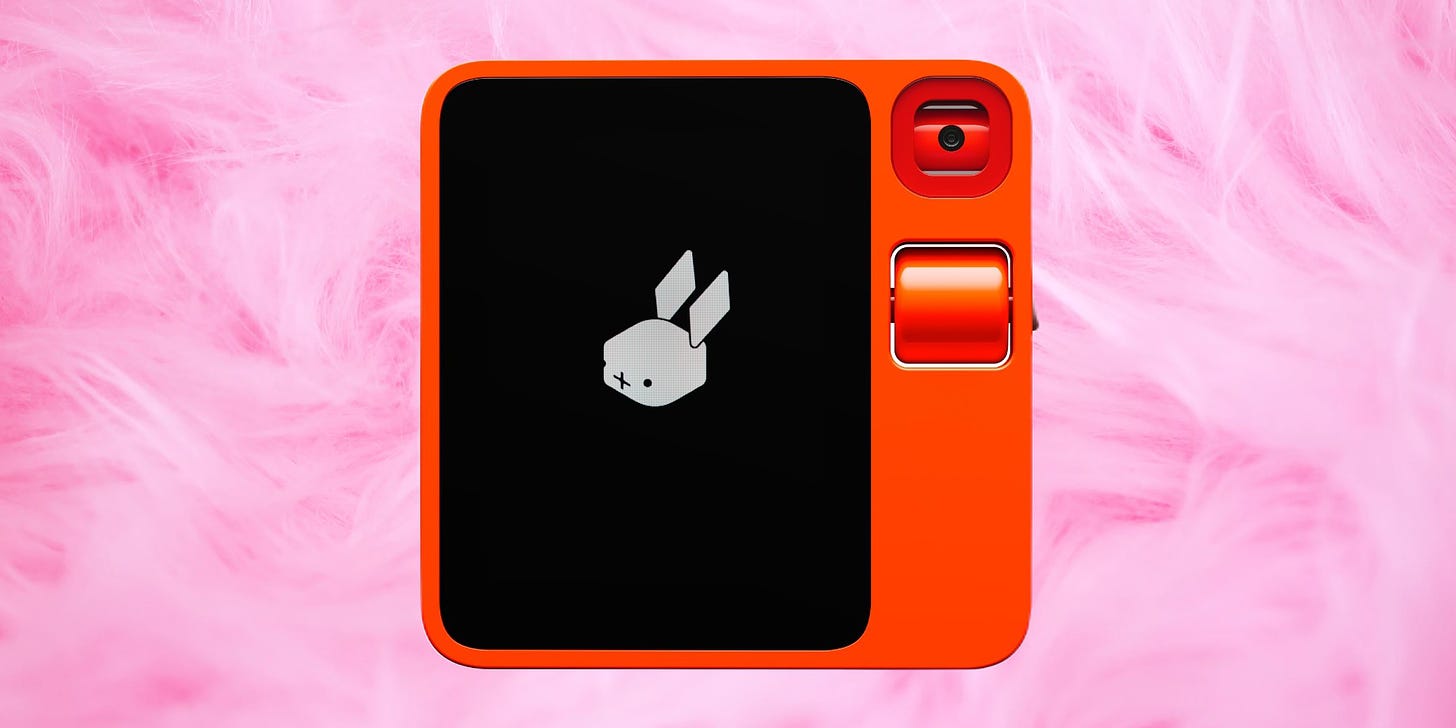 A square plastic device with a button and a camera and a screen showing a rabbit head icon