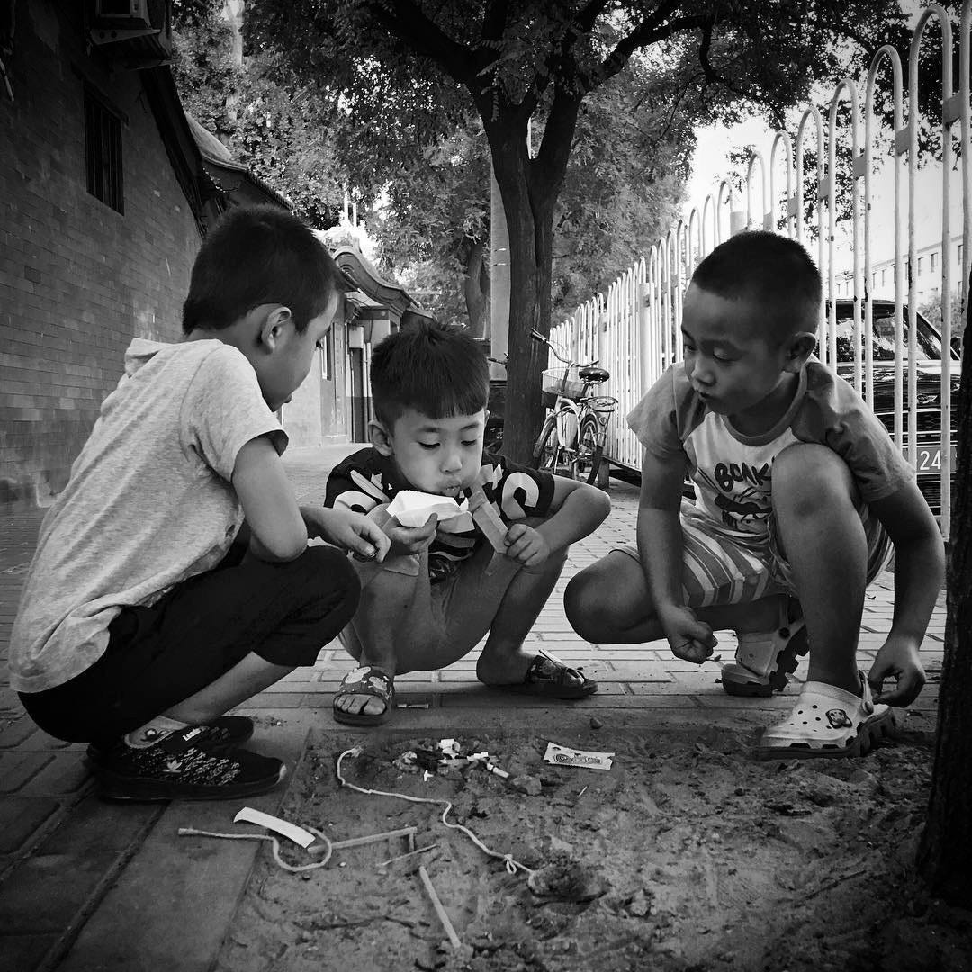 Kids playing on the street in Beijing.