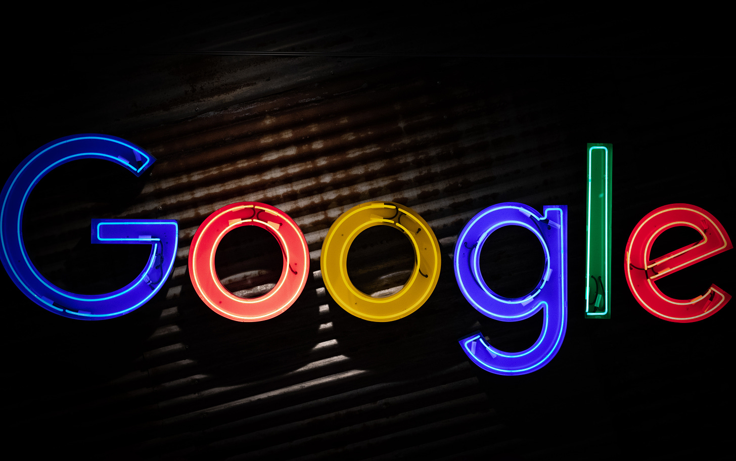 a neon sign that reads Google on a black background