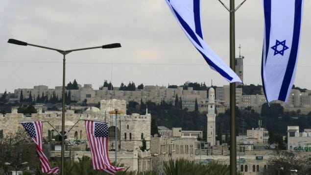 AMERICAN AND ISRAELI FLAGS FLY IN THE STREETS OF JERUSALEM.