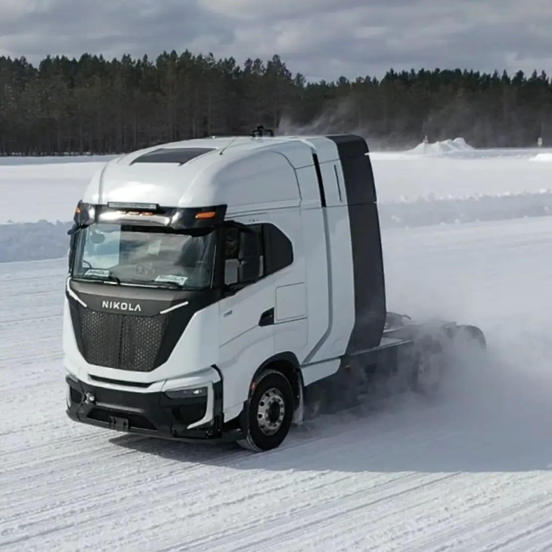 Nikola FCEV driving on a snowy road in a winter landscape.