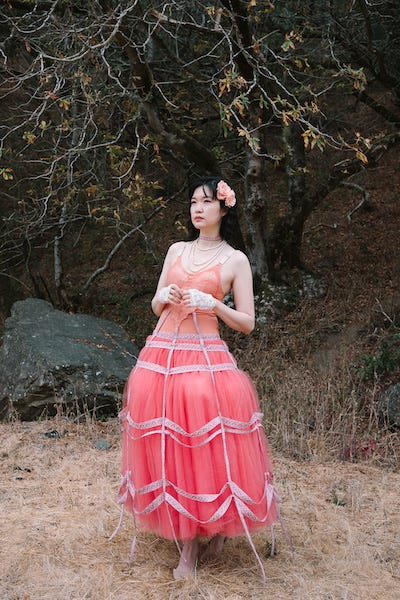 Woman wearing a upcycled ballgown by Mira Musank