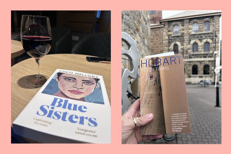 Coco Mellors Blue Sisters’ sat by a glass of red wine and a hand holding a copy of Hobart by Peter Timms.