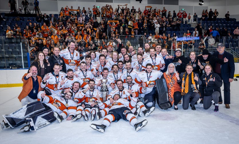 The Melbourne Mustangs posing with a trophy after winning the AIHL Championship game.