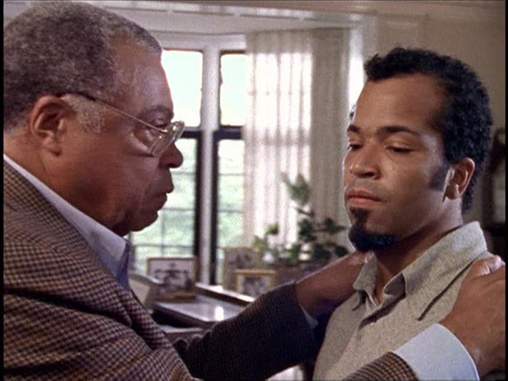 This still image from "Blood Ties (Part 3)" shows Felix Wilson (played by James Earl Jones, left) grasping the shoulders of his son, Hal Wilson (played by Jeffrey Wright, right). Felix looks directly at Hal, who glances downward, avoiding Felix's eyes. This still image from "Blood Ties (Part 3)" shows Felix Wilson (played by James Earl Jones, left) grasping the shoulders of his son, Hal Wilson (played by Jeffrey Wright, right). Felix looks directly at Hal, who glances downward, avoiding Felix's eyes.