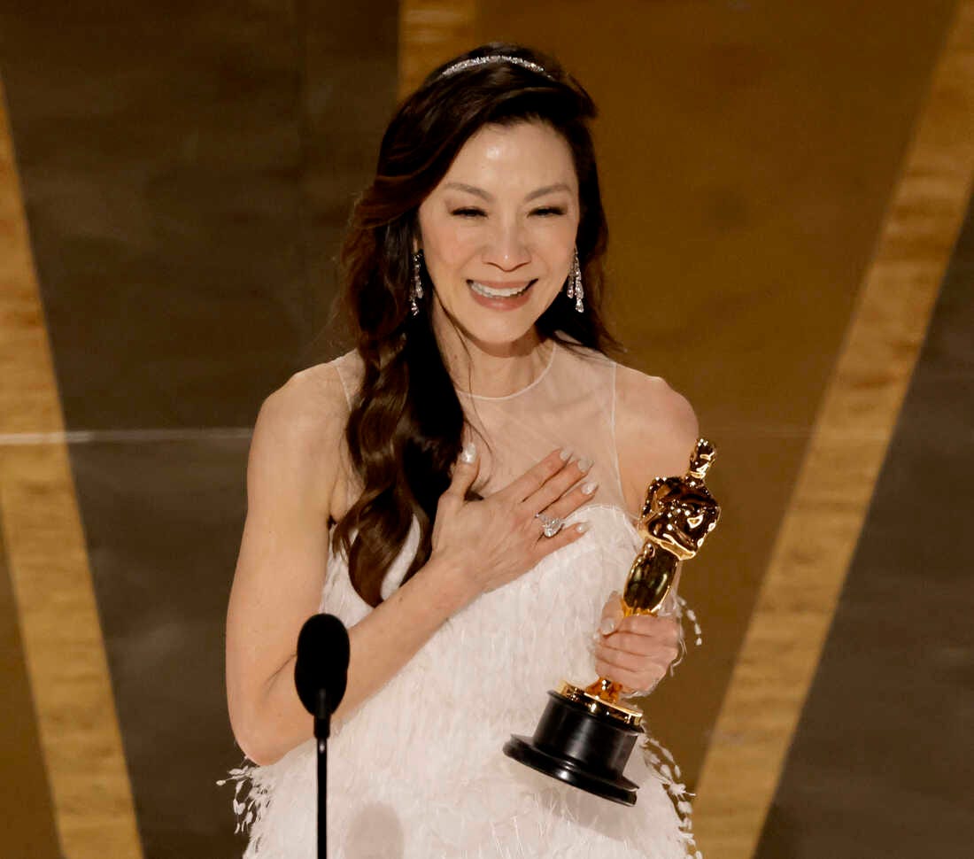 Michelle Yeoh holds her Oscar for Best Actress during her acceptance speech.